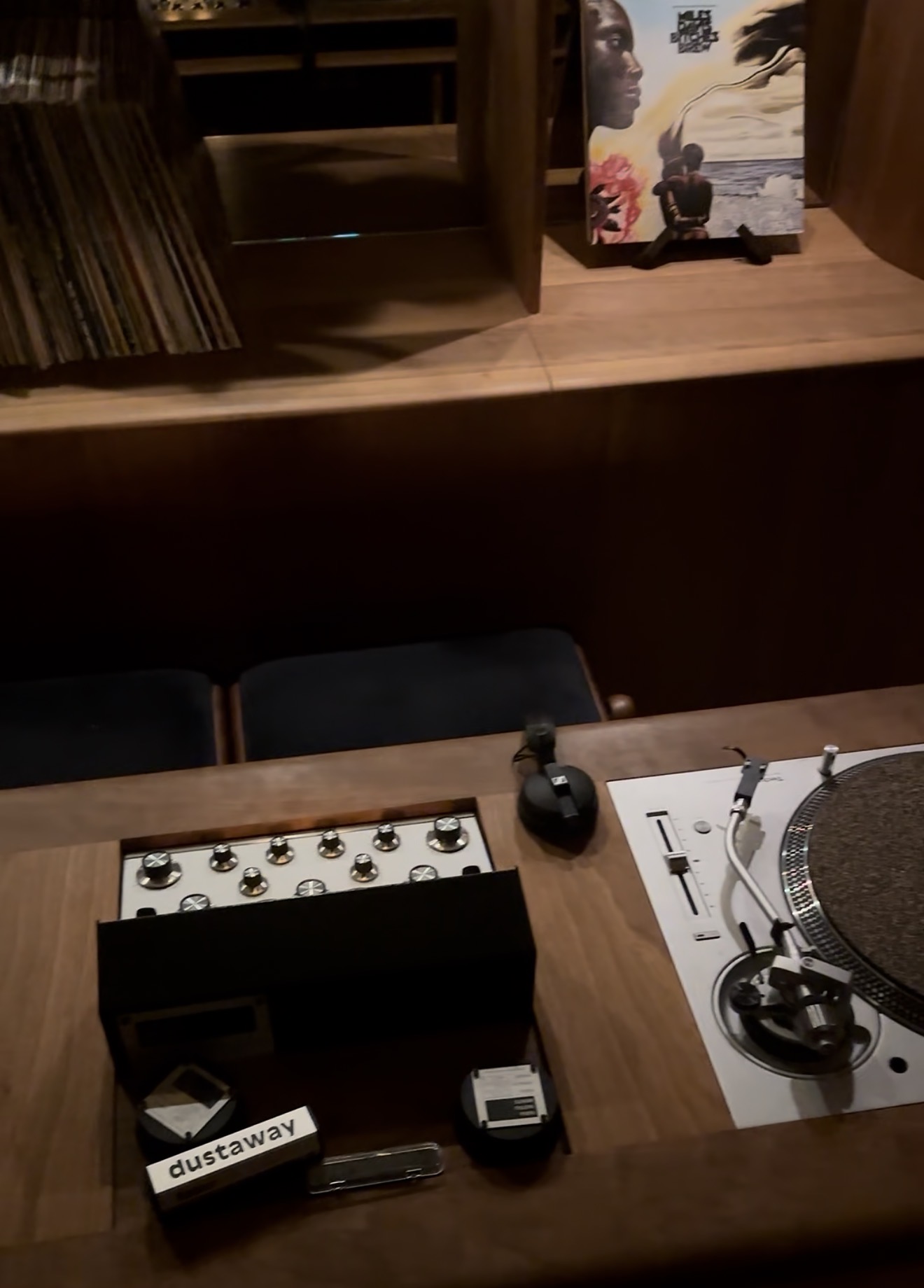 A closer look at the turntable and mixer built into CUE’s wooden DJ console.